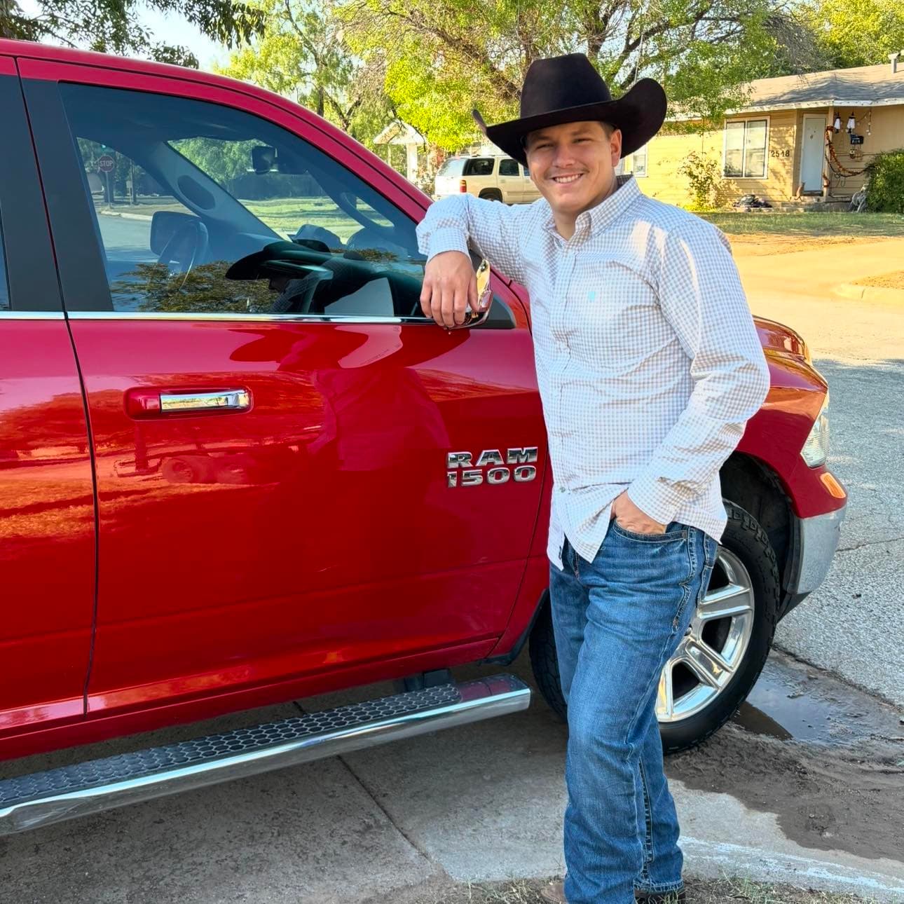Outwest Mowing owner beside his work truck in Abilene